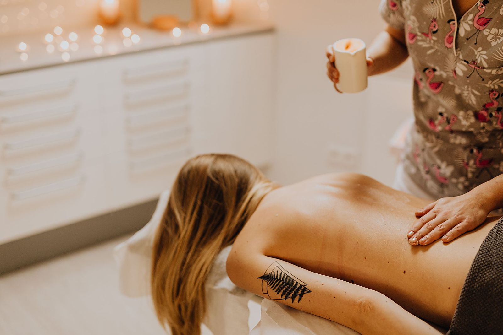 Signature full-body massage on a candle-lit treatment table